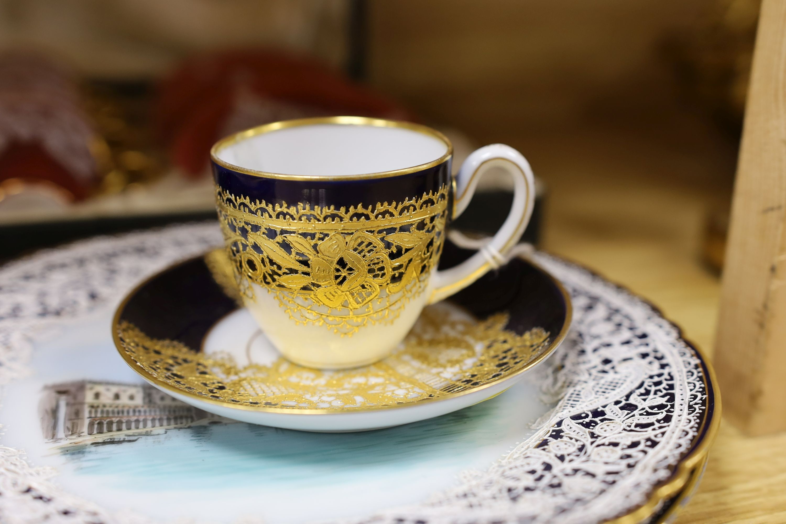 Venetian decorated Lace-pattern ceramics including a cased coffee set and a pair of plates painted with named views of Venice